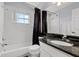 Bathroom featuring a shower and tub combo, white tiled walls and modern decor at 425 Eagle Ridge Dr # 425, Davenport, FL 33837