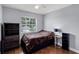 Simple bedroom featuring a ceiling fan, large window providing natural light, and modern decor at 425 Eagle Ridge Dr # 425, Davenport, FL 33837