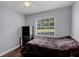 Bedroom featuring a ceiling fan, large window providing natural light, and simple decor at 425 Eagle Ridge Dr # 425, Davenport, FL 33837
