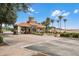 Elegant community entrance with stone columns, terracotta roof, water feature, and lush landscaping at 425 Eagle Ridge Dr # 425, Davenport, FL 33837
