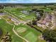 Expansive aerial view of the lush golf course and community with beautiful landscaping on a sunny day at 425 Eagle Ridge Dr # 425, Davenport, FL 33837