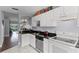 Bright kitchen featuring granite countertops, white cabinets, stainless sink and appliances, and a view to the Living Room at 425 Eagle Ridge Dr # 425, Davenport, FL 33837
