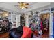 Eclectic living room filled with collectibles, fan and wooden floors at 425 Eagle Ridge Dr # 425, Davenport, FL 33837
