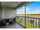 Screened patio with pond and green space view, furnished with seating at 425 Eagle Ridge Dr # 425, Davenport, FL 33837
