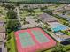 Aerial view of two tennis courts with community pool and clubhouse in the background at 425 Eagle Ridge Dr # 425, Davenport, FL 33837