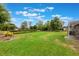 Spacious backyard with well-manicured lawn, lush landscaping, and mature trees at 441 Hightower Dr, Debary, FL 32713