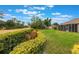Expansive backyard featuring green grass, manicured bushes, and views of surrounding trees at 441 Hightower Dr, Debary, FL 32713