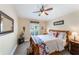 Cozy bedroom with neutral walls, ceiling fan, and comfortable bed adorned with a colorful quilt at 441 Hightower Dr, Debary, FL 32713