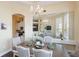 Dining room features chandelier, large mirror, and hardwood flooring at 441 Hightower Dr, Debary, FL 32713