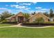 Charming single-story brick home featuring a manicured lawn and inviting walkway leading to the front door at 441 Hightower Dr, Debary, FL 32713