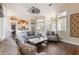 Bright open-concept living room with comfortable seating, view into kitchen, dark hard wood floors and lots of light at 441 Hightower Dr, Debary, FL 32713