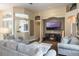 Cozy living room featuring neutral furniture, dark hard wood floors, with modern fireplace and décor at 441 Hightower Dr, Debary, FL 32713