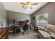 Home office featuring a ceiling fan, large window, comfortable seating, and professional audio equipment at 441 Hightower Dr, Debary, FL 32713