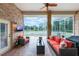 Enclosed brick patio featuring comfortable seating, a ceiling fan, and outdoor views at 441 Hightower Dr, Debary, FL 32713