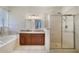 Elegant bathroom with a soaking tub, glass-enclosed shower, and granite-topped vanity at 4558 Redmond Pl, Sanford, FL 32771
