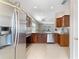Spacious kitchen boasts granite countertops, stainless appliances, and seamless flow to dining area at 4558 Redmond Pl, Sanford, FL 32771