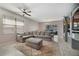 Comfortable living room featuring a plush sectional sofa, a ceiling fan, and neutral decor at 4558 Redmond Pl, Sanford, FL 32771