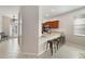 Inviting open-concept living space features a sleek breakfast bar connecting to the kitchen area at 4558 Redmond Pl, Sanford, FL 32771