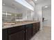 Bathroom features granite countertops, dark wood cabinets, and a glass-enclosed shower at 5013 E Fountainwood Dr, St Cloud, FL 34772