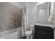 Bathroom displays a tiled tub-shower, granite vanity, and neutral paint, offering a clean and functional design at 5013 E Fountainwood Dr, St Cloud, FL 34772