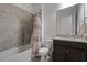 Well-lit bathroom featuring a tiled shower and tub combination and granite vanity at 5013 E Fountainwood Dr, St Cloud, FL 34772