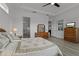 Bedroom boasts wood-look floors, tray ceiling, and neutral walls, creating a serene retreat at 5013 E Fountainwood Dr, St Cloud, FL 34772