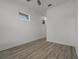 Small bedroom offers wood-look floors, white walls, and a single window, creating a cozy space at 5013 E Fountainwood Dr, St Cloud, FL 34772