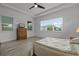 Well-lit bedroom shows wood-look floors, neutral paint, and large window providing plenty of natural light at 5013 E Fountainwood Dr, St Cloud, FL 34772