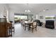 Elegant dining area with natural light, stylish furniture, and tile flooring at 5013 E Fountainwood Dr, St Cloud, FL 34772