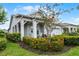 Inviting home with a covered porch, manicured landscaping, and a cozy rocking chair at 5013 E Fountainwood Dr, St Cloud, FL 34772