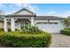 Charming single-story home featuring a well-manicured lawn and a bright white garage door at 5013 E Fountainwood Dr, St Cloud, FL 34772