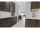 Spacious kitchen featuring dark wood cabinets, granite countertops, and stainless appliances at 5013 E Fountainwood Dr, St Cloud, FL 34772