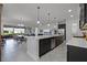 Open-concept kitchen featuring a large island, stainless steel appliances, and tile floors at 5013 E Fountainwood Dr, St Cloud, FL 34772