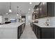 Stylish kitchen with granite countertops, stainless appliances, and dark cabinets at 5013 E Fountainwood Dr, St Cloud, FL 34772