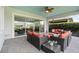 Relaxing screened lanai with comfortable seating, a ceiling fan, and brick flooring at 5013 E Fountainwood Dr, St Cloud, FL 34772
