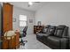 Comfortable living room with plush seating, ceiling fan, and natural light at 5013 E Fountainwood Dr, St Cloud, FL 34772