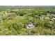 Areal view of a home surrounded by lush trees and beautiful landscape with a location marker at 5655 Oak Hollow Ln, Oviedo, FL 32765