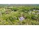 Areal view of a home surrounded by lush trees and beautiful landscape at 5655 Oak Hollow Ln, Oviedo, FL 32765