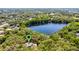 Aerial view of the lake, surrounding trees, and a home location pin at 5655 Oak Hollow Ln, Oviedo, FL 32765
