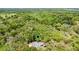 Areal view of a home surrounded by lush trees and beautiful landscape with a location marker at 5655 Oak Hollow Ln, Oviedo, FL 32765