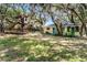 Large backyard with mature trees and a custom treehouse at 5655 Oak Hollow Ln, Oviedo, FL 32765