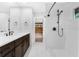 Modern bathroom featuring a double vanity, marble shower, and neutral walls at 5655 Oak Hollow Ln, Oviedo, FL 32765