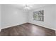 Bedroom with hardwood floors, a ceiling fan, and a view of the lake at 5655 Oak Hollow Ln, Oviedo, FL 32765