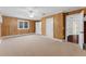 Wood paneled bedroom with carpeted floors, a ceiling fan, and natural light from the window at 5655 Oak Hollow Ln, Oviedo, FL 32765