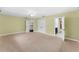 Open bedroom with a neutral carpet, double closet, and multiple entryways at 5655 Oak Hollow Ln, Oviedo, FL 32765