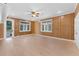 A sunlit bedroom featuring knotty pine walls, recessed lights, and a ceiling fan at 5655 Oak Hollow Ln, Oviedo, FL 32765