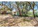 Charming cottage with a well-manicured yard and verdant surroundings at 5655 Oak Hollow Ln, Oviedo, FL 32765