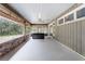 A spacious covered patio with a hot tub, brick trim, and views of nature at 5655 Oak Hollow Ln, Oviedo, FL 32765