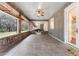 A large covered patio with brick trim, ceiling fans, and an outside view of the grounds at 5655 Oak Hollow Ln, Oviedo, FL 32765
