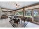 A large covered patio featuring wicker furniture, brick trim, ceiling fans, and an outside view at 5655 Oak Hollow Ln, Oviedo, FL 32765